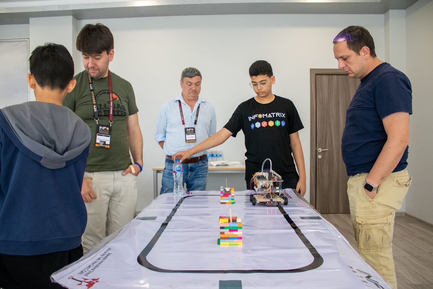 A student demonstrating a robot to Infomatrix judges